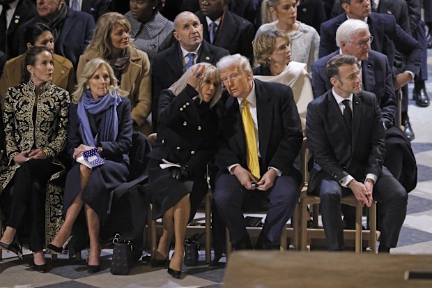 President Emmanuel Macron's wife Brigitte Macron talks with US President-elect Donald Trump as they sit alongside daughter of US President Joe Biden, Ashley Biden, left, First Lady Jill Biden, second left, and French President Emmanuel Macron in Notre Dame Cathedral as France's iconic cathedral is formally reopening its doors for the first time since a devastating fire nearly destroyed the 861-year-old landmark in 2019, Saturday Dec.7, 2024 in Paris ( Ludovic Marin, Pool via AP)