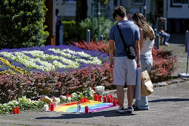 People lay flowers near the scene of a knife attack in Solingen city center, Germany