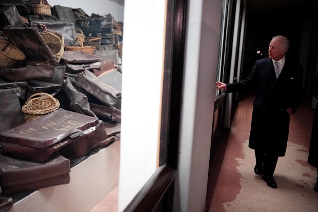 OSWIECIM, POLAND - JANUARY 27: King Charles III looks at suitcases during a tour of Auschwitz-Birkenau in Poland, following commemorations to mark 80 years since the liberation of the concentration camp on January 27, 2025 in Oswiecim, Poland. The Nazis built and operated the Auschwitz complex of concentration camps during World War II initially for slave labor and later for the mass extermination of Jews and other undesirables. Approximately 1.1 million people died at Auschwitz, most of them in