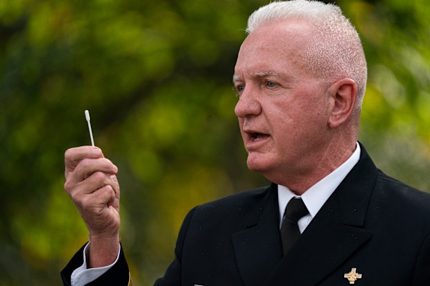 Admiral Brett Giroir, Assistant Secretary for Health, Department of Health and Human Services, shows a nasal swab during a coronavirus testing event with President Donald Trump, in the Rose Garden of the White House, Monday, Sept. 28, 2020, in Washington. (AP Photo/Evan Vucci)