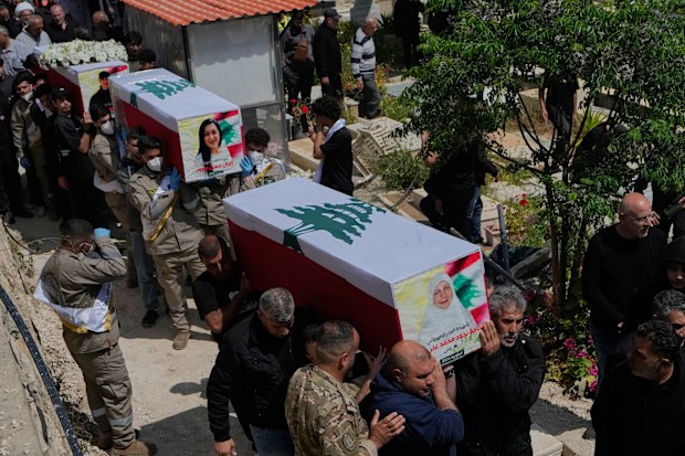 Mourners carry the coffins of civilians who were killed in the war between Hezbollah and Israel during a mass funeral in Bazouriyeh village, south Lebanon, Monday, April 20, 2026. (AP Photo/Mohammed Zaatari)