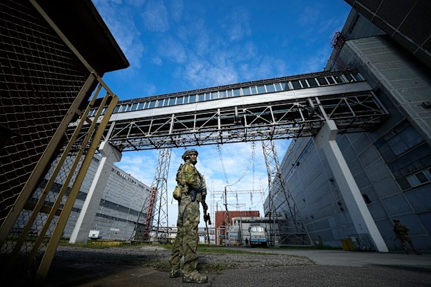 A Russian serviceman guards an area of the Zaporizhzhia Nuclear Power Station in territory under Russian military control, southeastern Ukraine, May 1, 2022. 