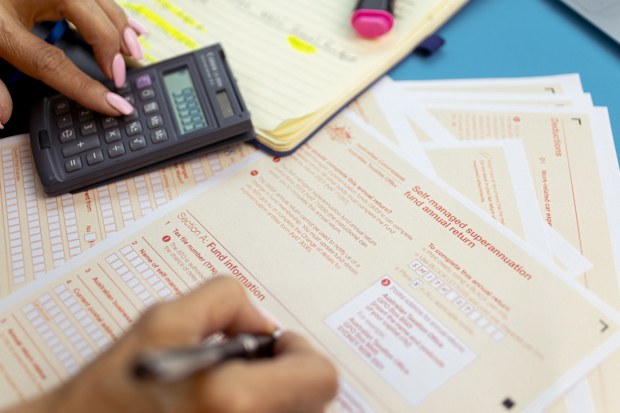 Generic picture of someone filling out a tax return.