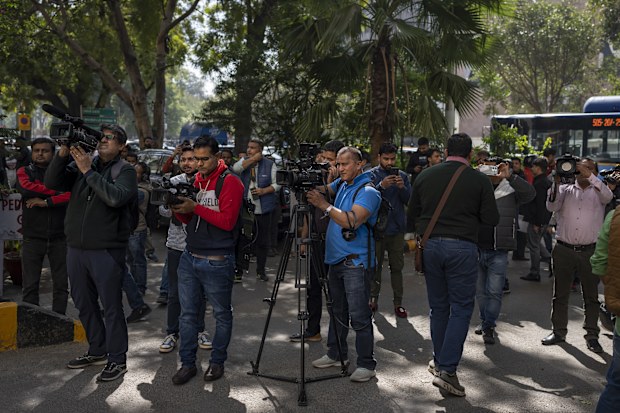 Media personnel report standing outside a building housing BBC office in New Delhi, India, Tuesday, Feb. 14, 2023. 