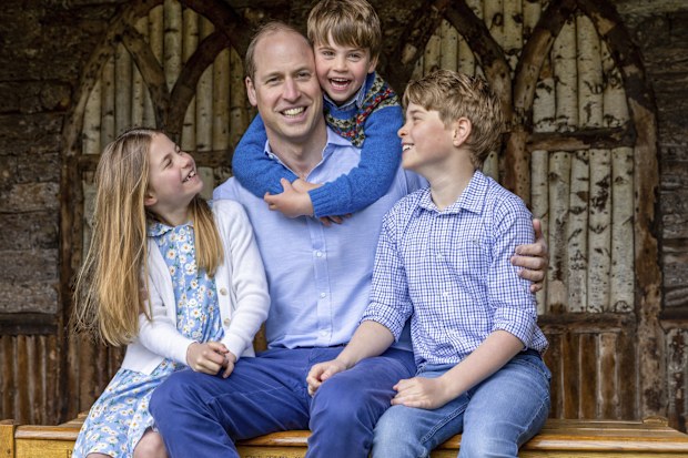 William, the Prince of Wales, sits with his children Princess Charlotte, Prince Louis and Prince George, right, Saturday June 17, 2023, ahead of Father's Day. (Millie Pilkington/Kensington Palace via AP)