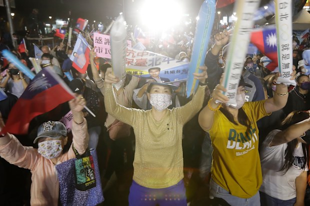 Supporters of Taiwan Kuomintang party Taipei city mayoral candidate Wayne Chiang cheer in Taipei.