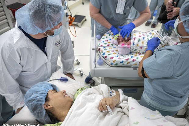 Sandy and Jesse seeing their conjoined twin daughters for the first time.