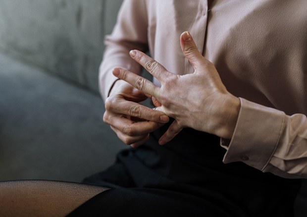 Stock photo of a woman removing her wedding ring, divorce.