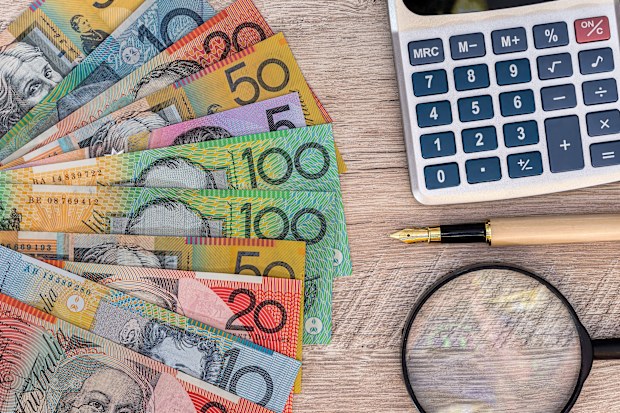 australian money next to a calculator