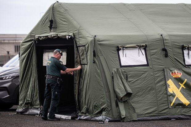 A member of the Guardia Civil finishes erecting a tent at an expected reception point for passengers from the MV Hondius at the Granadilla Port.