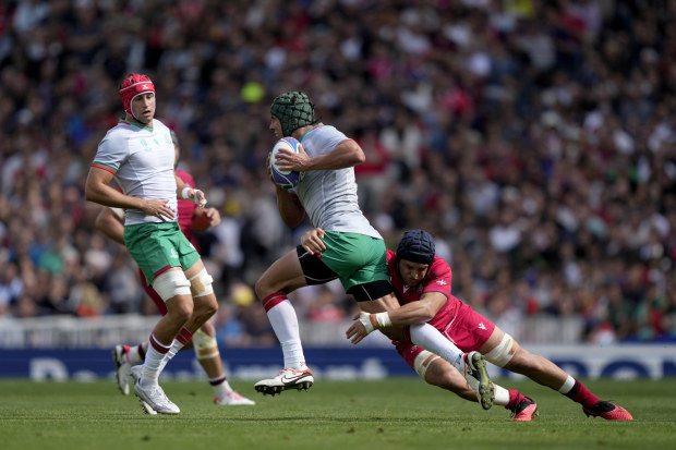Portugal's Pedro Bettencourt, left, is tackled by Georgia's Tornike Jalagonia during the Rugby World Cup.