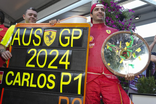 Ferrari driver Carlos Sainz of Spain poses with his trophy after winning the Australian Grand Prix at Albert Park.