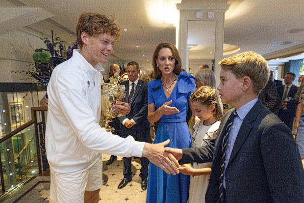LONDON, ENGLAND - JULY 13: Jannik Sinner of Italy holds the Gentlemen's Singles Trophy and shakes hands with Prince George of Wales alongside Catherine, Princess of Wales, Patron of the All England Lawn Tennis Club and Princess Charlotte of Wales in the Clubhouse after winning the Gentlemen's Singles Final at The Championships 2025 Held at The All England Lawn Tennis Club on July 13, 2025 in London, England. (Photo by Andrew Parsons - Pool/Getty Images)