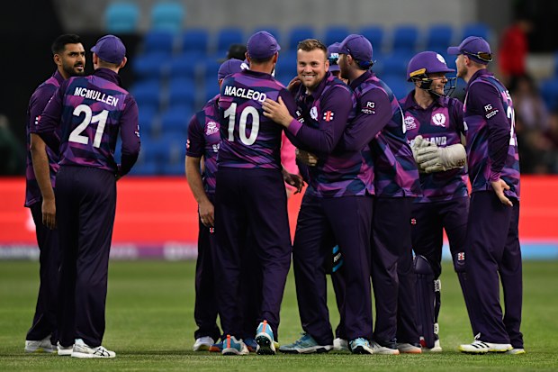 Mark Watt of Scotland celebrates with teammates after running out Akeal Hosein of the West Indies during the World Cup.