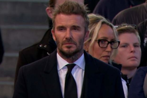 David Beckham eventually walked through Westminster Hall around 3.20pm, removing his cap and revealing a black tie and suit underneath his coat