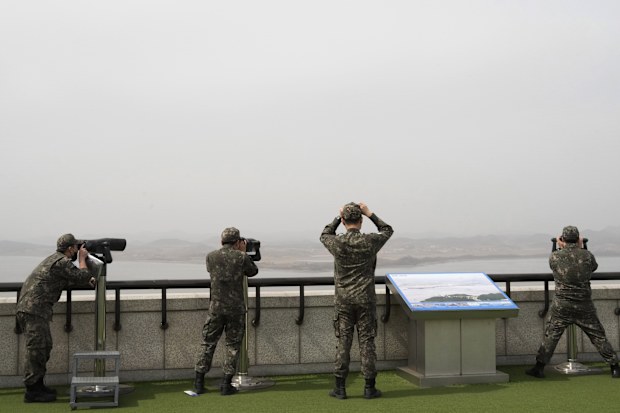 South Korean army soldiers watch the North Korea side from the Unification Observation Post in Paju, South Korea, near the border with North Korea, Friday, March 24, 2023. 