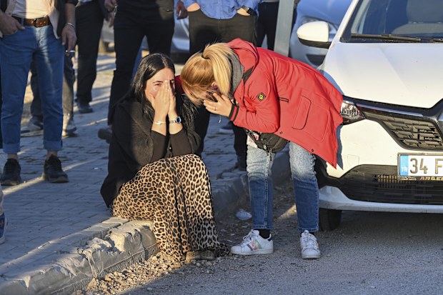 People gather outside of Turkish Aerospace Industries Inc. at the outskirts of Ankara, Turkey, Wednesday, Oct. 23, 2024. 