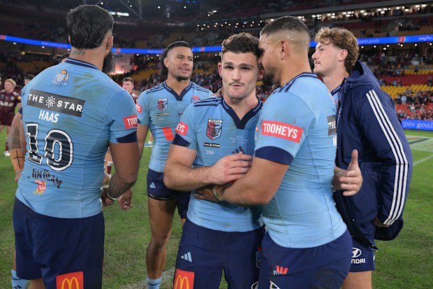 Nathan Cleary gets a hug from Latrell Mitchell after the Blues won Origin I.