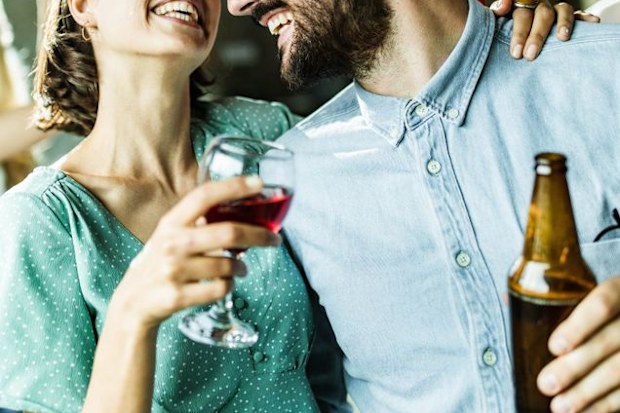 Woman drinking wine with friend