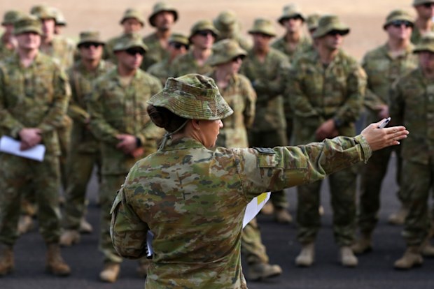 Australian Army Reserve and Regular personnel are seen during a roll call ahead of departing the Holsworthy Barracks to support bushfire efforts across NSW