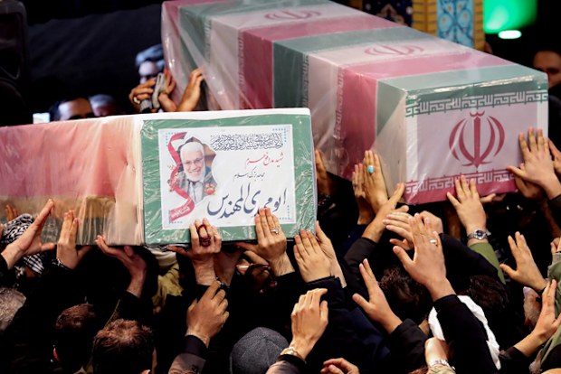 Iranian mourners carrying caskets of slain Iranian military commander Qasem Soleimani (L) and Iraqi paramilitary chief Abu Mahdi al-Muhandis at Tehran University in the Iranian capital