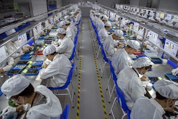 Workers assemble parts for e-cigarettes on the production line at Kanger Tech, one of China's leading manufacturers of vaping products.