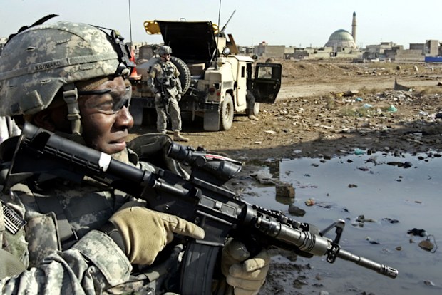 In this 2006 photo a US Army soldier from the 2nd Infantry Battalion, 17th Field Artillery Regiment looks on before the start of a mission to monitor a mosque during Friday prayers in Baghdad, Iraq.
