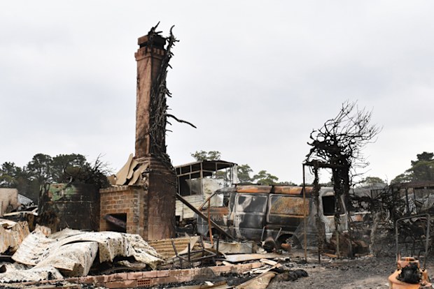 The burnt out remains of a house is seen from a bushfire in the Southern Highlands town of Wingello, 160km south west of Sydney