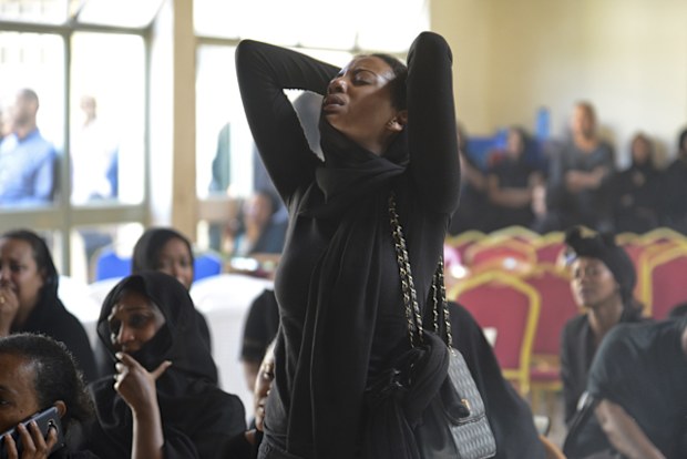 Mourners attend a memorial service held by an association of Ethiopian airline pilots, at which framed photographs of seven crew members were on display, in Addis Ababa, Ethiopia Monday, March 11, 2019. Authorities in Ethiopia, China and Indonesia grounded all Boeing 737 Max 8 aircraft following the crash of an Ethiopian Airlines jetliner that killed 157 people, and investigators found the flight recorders from the field where the plane went down. 