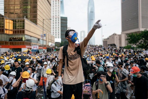 A protester makes a gesture during a protest in Hong Kong. Large crowds of protesters gathered in central Hong Kong as the city braced for another mass rally in a show of strength against the government over a divisive plan to allow extraditions to China. 