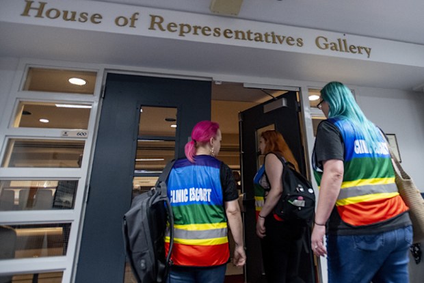 Women's heath clinic escorts walk into the gallery to watch debate on the abortion ban bill at the Alabama Statehouse in Montgomery, Alabama.