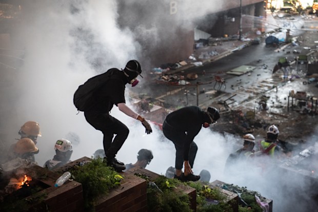 The anti-government protesters barricaded themselves inside Polytechnic last week. Police surrounded the area on Sunday night and began moving in after issuing an ultimatum for people to leave the area. The crowd wore raincoats and carried umbrellas to shield themselves from police water cannons. 