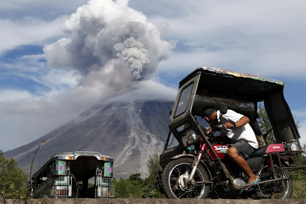 A Filipino villager looks on as Mayon Volcano erupts anew in Legaspi city, Albay province, Philippines in January 2018. 