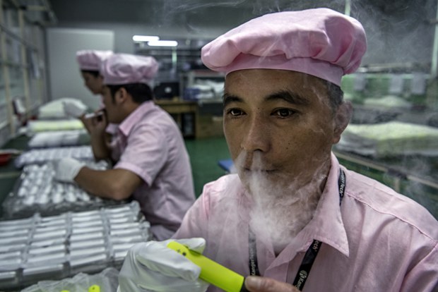 A worker tests an e-cigarette on the production line at Kanger Tech, one of China's leading manufacturers of vaping products,  in Shenzhen, China.