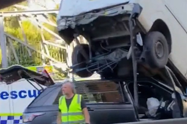 The dramatic crash, left the van teetering in the air on top of the other vehicle.It happened at Moore Park, on the edge of Sydney's CBD, and caused long queues for traffic heading out on Boxing Day afternoon.