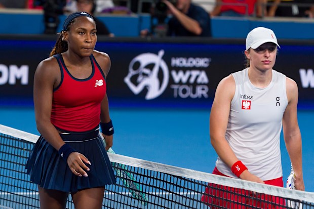 Coco Gauff and Iga Swiatek meet at the net after their women's singles match in the United Cup final.