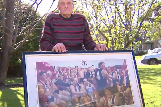 Alan Morrow with a picture of St Kilda's premiership-winning team.