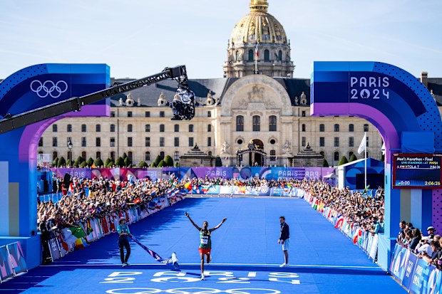 Tamirat Tola of Ethiopia crosses the finish line to win gold.
