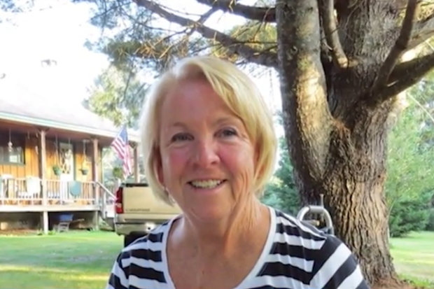 Kim Durkee smiling in front of a tree.