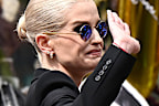 Kelly Osbourne (left); Jack Osbourne (right) view tributes to the late Ozzy Osbourne from fans as his funeral cortege travels through his home city of Birmingham on July 30, 2025 in Birmingham, England