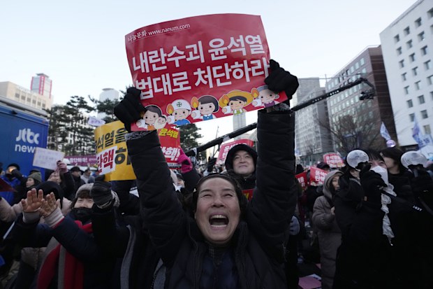 Protesters celebrate after impeachment vote of President Yoon Suk Yeol at the National Assembly in Seoul 