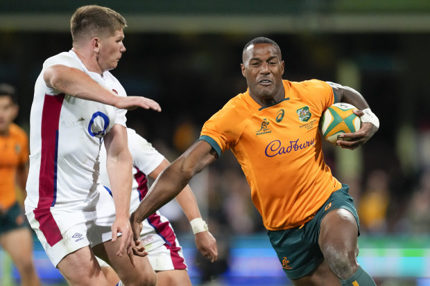 Australia's Suliasi Vunivalu runs at England's Owen Farrell.