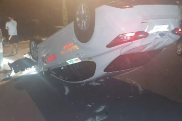 A taxi driver has crashed into parked vehicles and flipped his car in Adelaide
