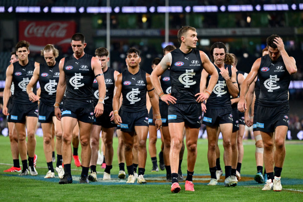 Carlton players trudge off.