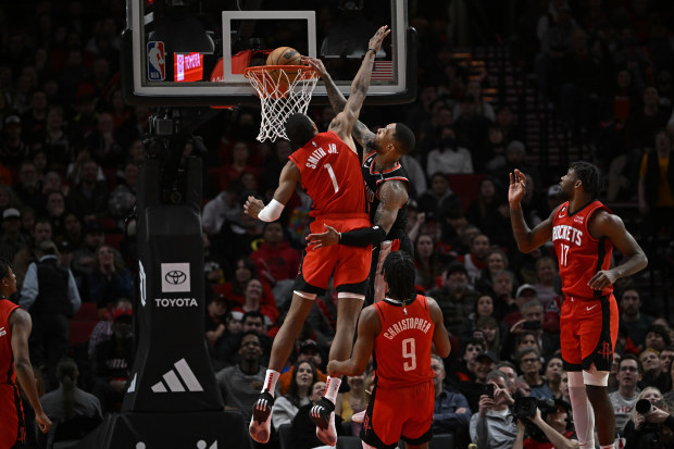 PORTLAND, OREGON - FEBRUARY 26: Damian Lillard #0 of the Portland Trail Blazers dunks over Jabari Smith Jr. #1 of the Houston Rockets during the fourth quarter at the Moda Center on February 26, 2023 in Portland, Oregon. The Portland Trail Blazers won 131-114. NOTE TO USER: User expressly acknowledges and agrees that, by downloading and or using this photograph, User is consenting to the terms and conditions of the Getty Images License Agreement. (Photo by Alika Jenner/Getty Images)