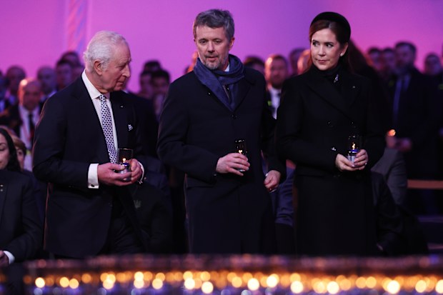 OSWIECIM, POLAND - JANUARY 27: (L-R) King Charles III and King Frederik X of Denmark and Queen Mary of Denmark wait to place a lit candle as tribute is paid to the Holocaust victims during the ceremony for the 80th anniversary of the liberation of the Auschwitz camp on January 27, 2025 in Oswiecim, Poland. The Nazis built and operated the Auschwitz complex of concentration camps during World War II initially for slave labor and later for the mass extermination of Jews and other undesirables. App