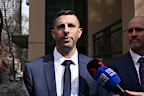 Michael Pell (centre) leaves the Melbourne Magistrates Court in Melbourne.