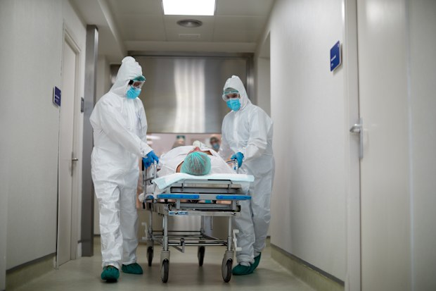 Hospital staff moving bed