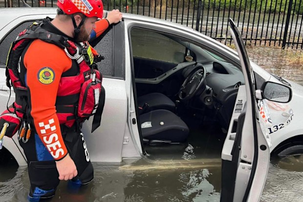 An SES car stuck in knee-deep floods in Clyde, Sydney.