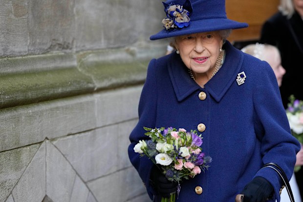 Britain's Queen Elizabeth II, Patron, holds flowers as she leaves after attending a Service of Thanksgiving to mark the Centenary of the Royal British Legion at Westminster Abbey, in London, Tuesday, Oct. 12, 2021. (AP Photo/Frank Augstein, Pool)